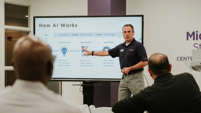 Dr. Rod McRae presenting a How AI Works slide in the CMGS